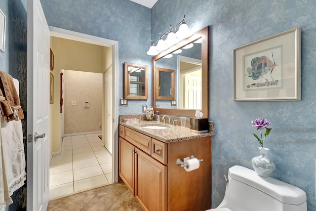 bathroom featuring toilet, wallpapered walls, tile patterned flooring, and vanity