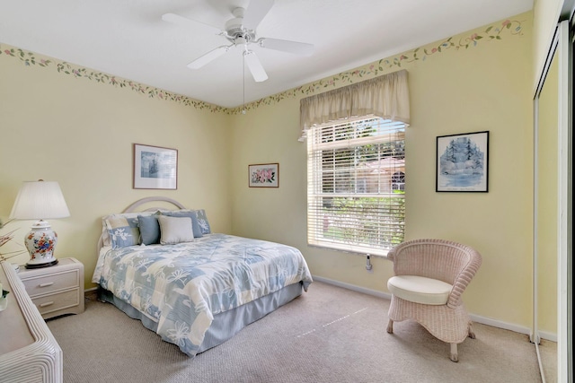 bedroom with ceiling fan, baseboards, and light colored carpet