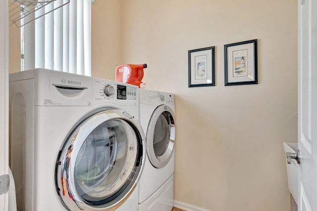 clothes washing area featuring laundry area and separate washer and dryer