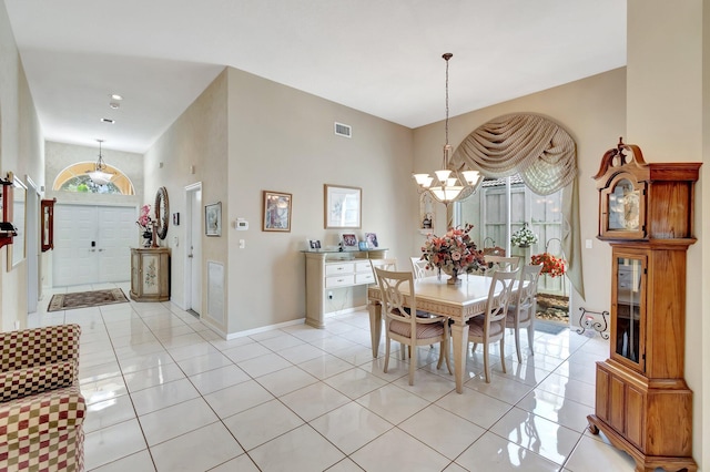 dining room with light tile patterned floors, baseboards, visible vents, and a notable chandelier