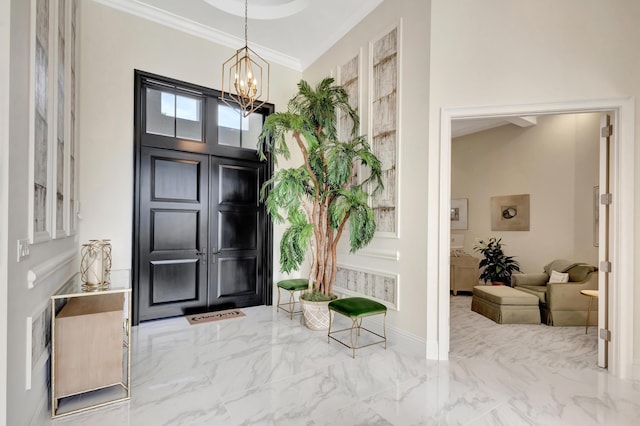 entrance foyer with marble finish floor, a notable chandelier, crown molding, and baseboards