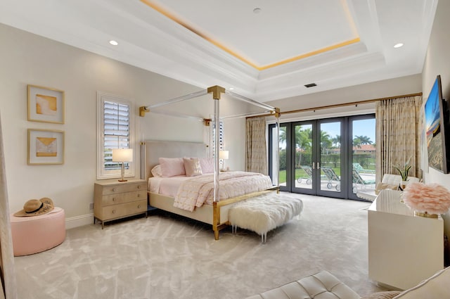 bedroom featuring a raised ceiling, french doors, access to exterior, crown molding, and carpet flooring