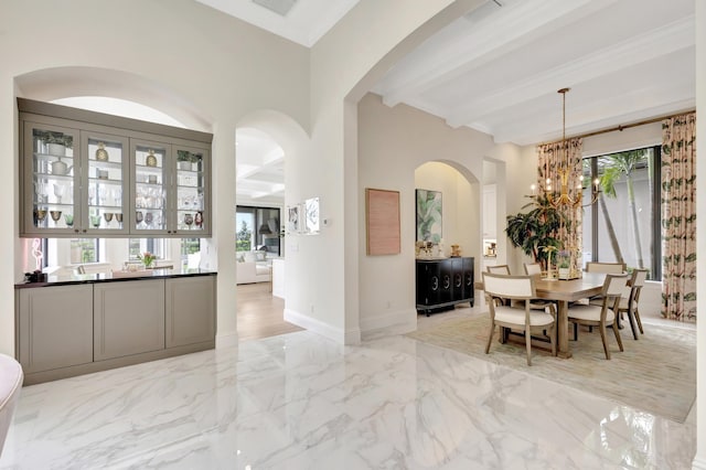 dining area featuring arched walkways, baseboards, marble finish floor, beamed ceiling, and an inviting chandelier