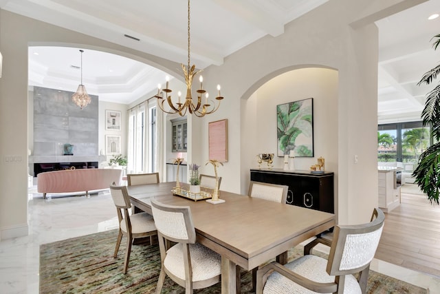 dining space featuring crown molding, baseboards, coffered ceiling, and beamed ceiling