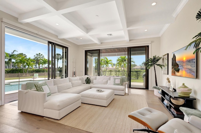 living room with coffered ceiling, beam ceiling, and a healthy amount of sunlight