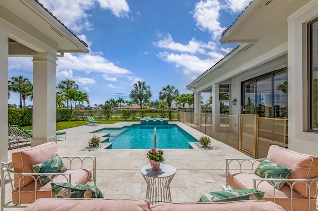 view of swimming pool featuring a patio area, a pool with connected hot tub, fence, and outdoor lounge area