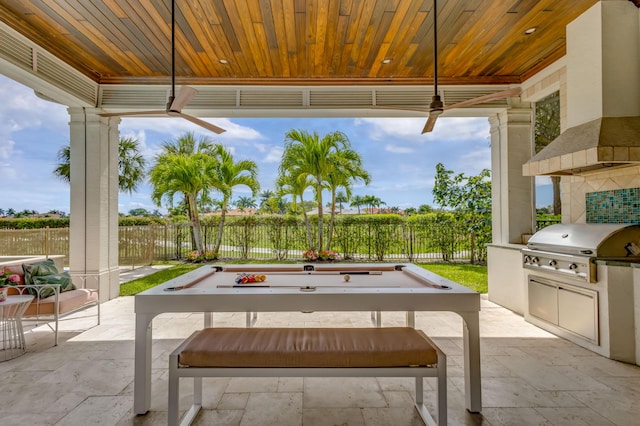 view of patio with exterior kitchen, fence, grilling area, and a ceiling fan