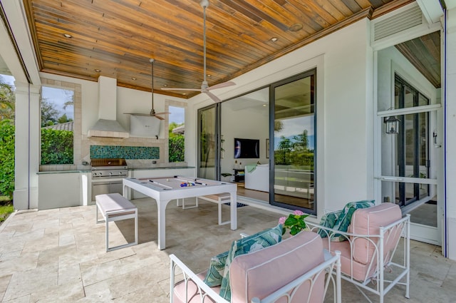 view of patio / terrace featuring exterior kitchen, ceiling fan, and grilling area