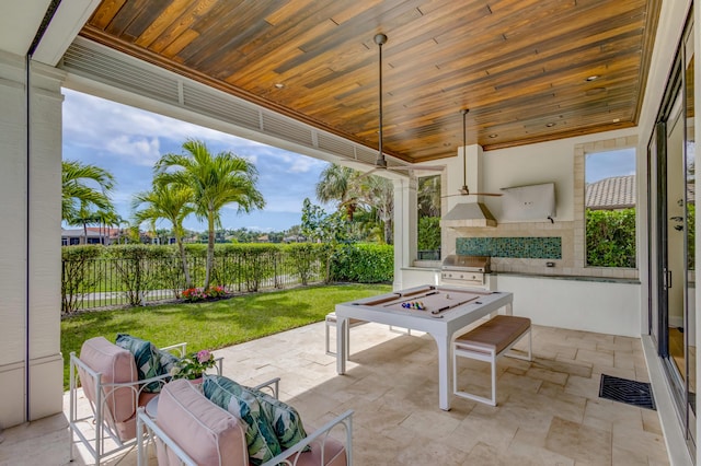 view of patio featuring an outdoor kitchen, fence, visible vents, and a grill