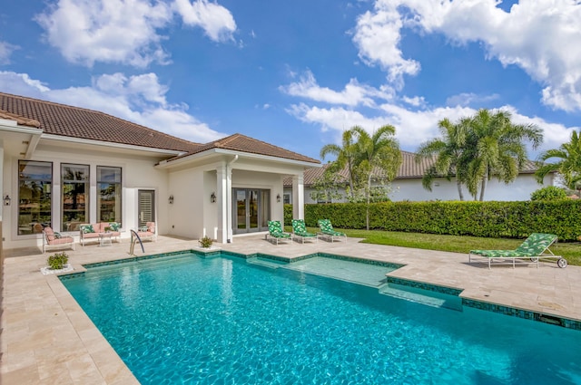 view of swimming pool featuring a patio area, a fenced in pool, and french doors