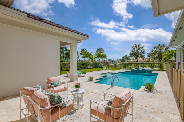 view of pool with a patio area, a pool with connected hot tub, and fence