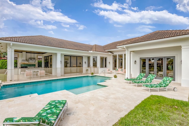 pool featuring french doors and a patio area