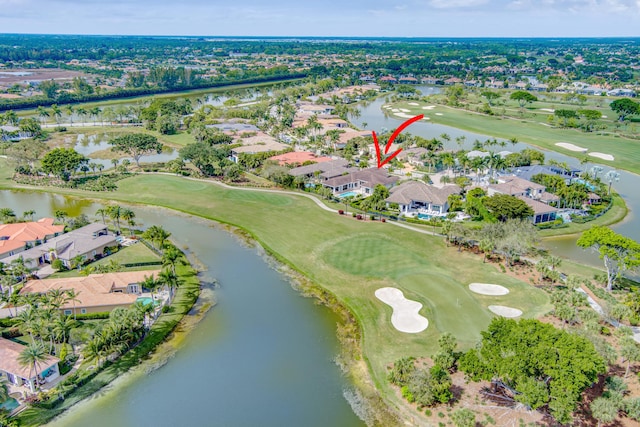 aerial view with view of golf course, a water view, and a residential view