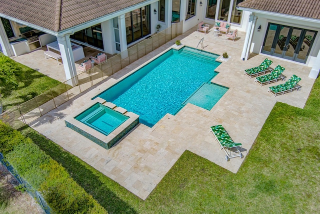 view of swimming pool with a lawn, a patio area, and a pool with connected hot tub