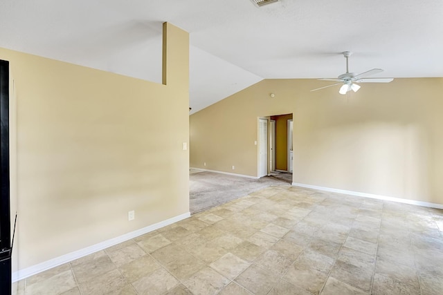 spare room featuring lofted ceiling, ceiling fan, visible vents, and baseboards