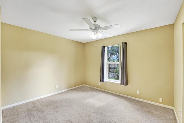 unfurnished room featuring ceiling fan, carpet floors, and baseboards