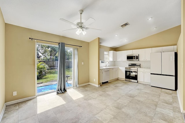 kitchen with stainless steel appliances, light countertops, visible vents, decorative backsplash, and white cabinets