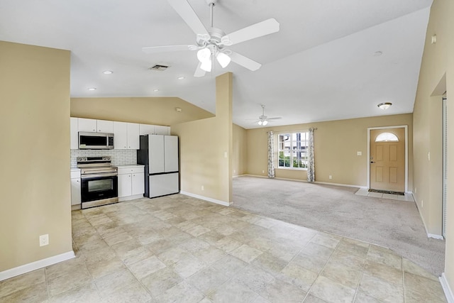 kitchen with stainless steel appliances, lofted ceiling, visible vents, open floor plan, and white cabinetry