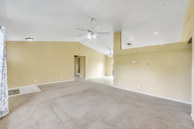 unfurnished room featuring lofted ceiling, light colored carpet, a ceiling fan, a textured ceiling, and baseboards