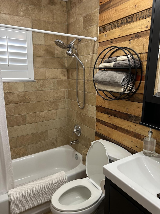 bathroom with toilet, shower / tub combo, vanity, and wooden walls