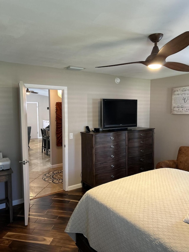 bedroom with baseboards, dark wood-style flooring, and a ceiling fan