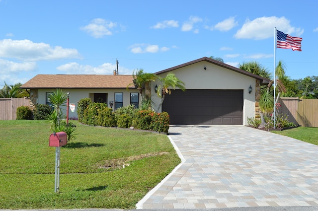 ranch-style home featuring a front lawn, stucco siding, a garage, and fence