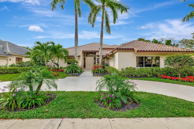 mediterranean / spanish-style home featuring a tile roof and stucco siding