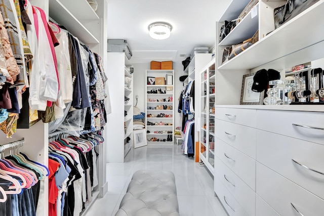 walk in closet with light tile patterned floors