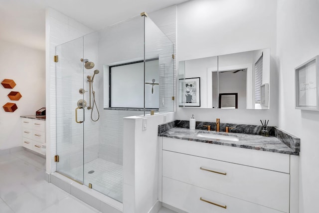 bathroom featuring a shower stall and vanity