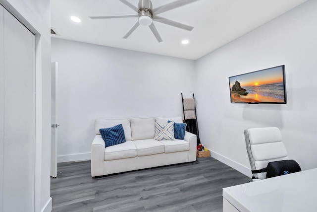 office space featuring ceiling fan, visible vents, baseboards, and dark wood-style flooring