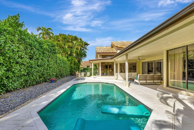 view of pool with a fenced in pool, an outdoor hangout area, a ceiling fan, a patio area, and a fenced backyard