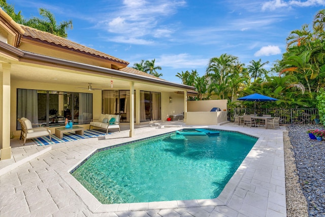 view of pool with ceiling fan, a patio, fence, and a fenced in pool