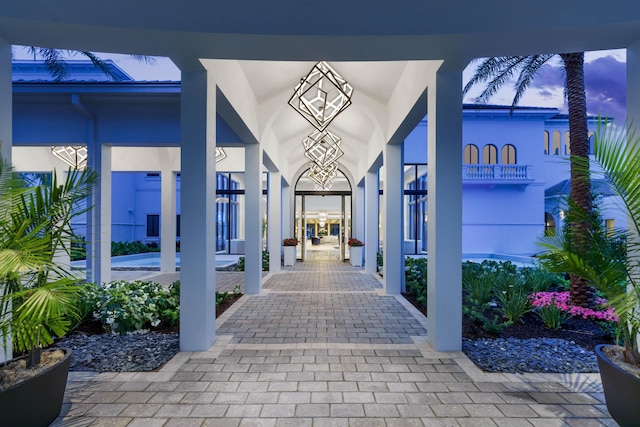 exterior entry at dusk featuring stucco siding