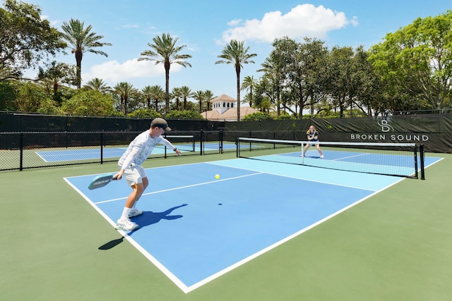 view of tennis court with fence