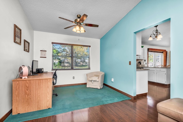 office with dark wood-style floors, a textured ceiling, baseboards, and ceiling fan with notable chandelier