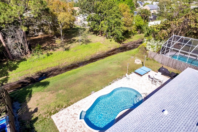 view of pool featuring a patio, a yard, fence, and a fenced in pool