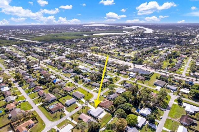 drone / aerial view with a water view and a residential view