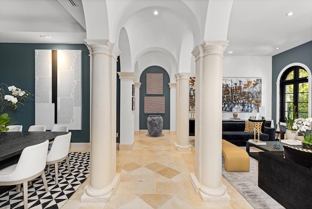 interior space with arched walkways, decorative columns, and recessed lighting