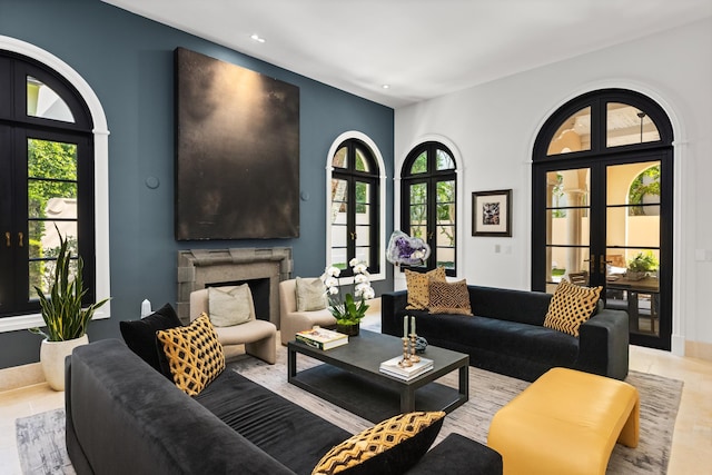 living area with a wealth of natural light, french doors, a fireplace, and recessed lighting