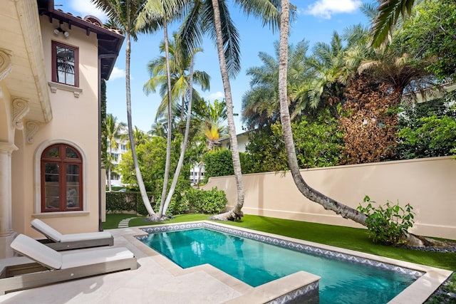 view of pool featuring fence private yard, french doors, a fenced in pool, and a patio