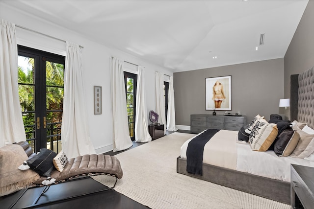 bedroom with lofted ceiling, french doors, access to outside, and baseboards