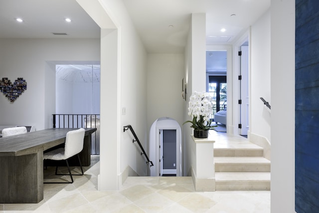 interior space with recessed lighting, visible vents, and an upstairs landing