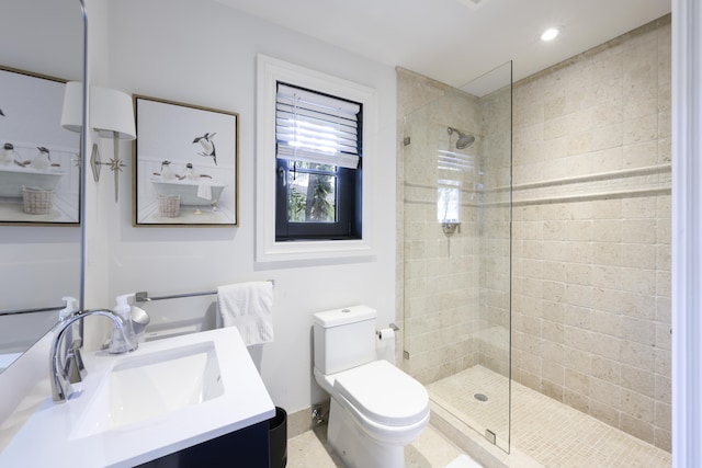 bathroom with baseboards, vanity, toilet, and walk in shower