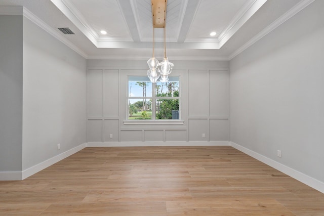 unfurnished room with ornamental molding, light wood-style flooring, visible vents, and a decorative wall