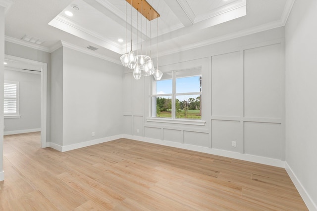 unfurnished room with light wood-style floors, visible vents, ornamental molding, and a decorative wall