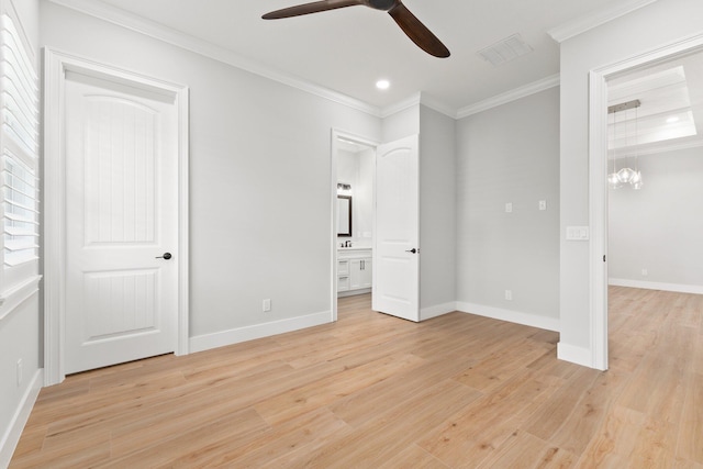 unfurnished bedroom featuring crown molding, visible vents, light wood-style floors, ensuite bath, and baseboards