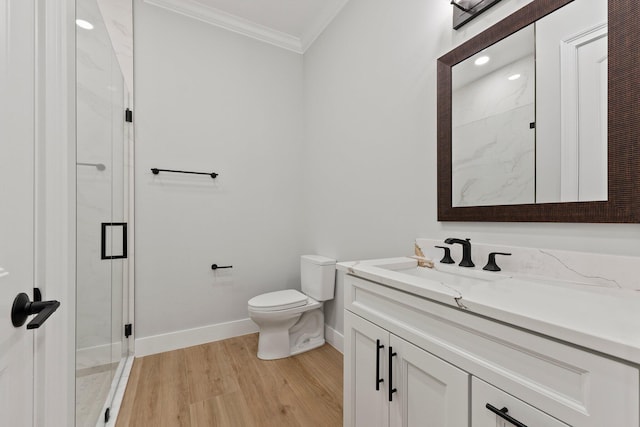 bathroom with a marble finish shower, baseboards, toilet, ornamental molding, and vanity