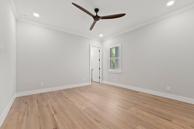 spare room with light wood-style flooring, baseboards, and crown molding