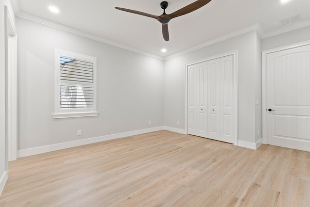 unfurnished bedroom with light wood-type flooring, visible vents, crown molding, and baseboards