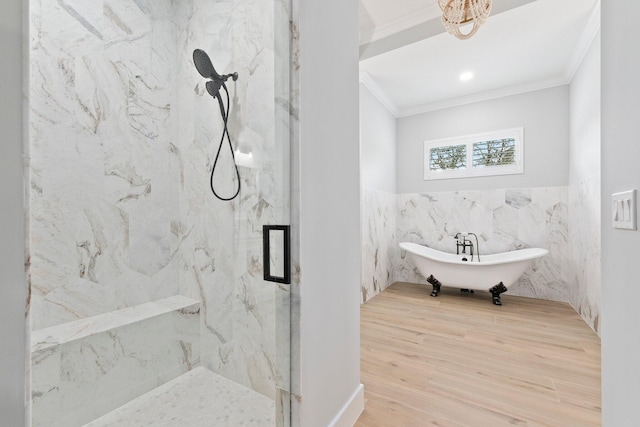 full bathroom with wood finished floors, a soaking tub, a marble finish shower, and crown molding